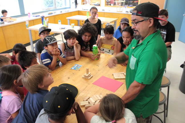 Dion Metcalfe uses Jenga tiles July 23 to explain how Inuksuit are never symmetrical like how they're often portrayed in popular culture. These Inuit children are attending a free day camp offered by the Ottawa Inuit Children's Centre. The camps — one week in July and one week in August — offer urban Inuit families an opportunity for their children to socialize with other Inuit, brush up on their Inuktitut, play games and sports, do crafts and maybe learn a little hip hop dancing. Read more about the camp later, on nunatsiaqonline.ca. (PHOTO BY LISA GREGOIRE)