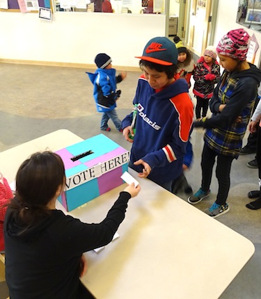 Kiilinik High School students line up Oct. 16 to vote in their school's mock election, carried by the NDP. (PHOTO BY JANE GEORGE)