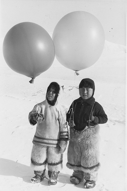 Two boys from Arctic Bay holding radiosonde balloons, around 1951. Photographed by John G. Cormack. (PHOTO COURTESY HBC ARCHIVES)