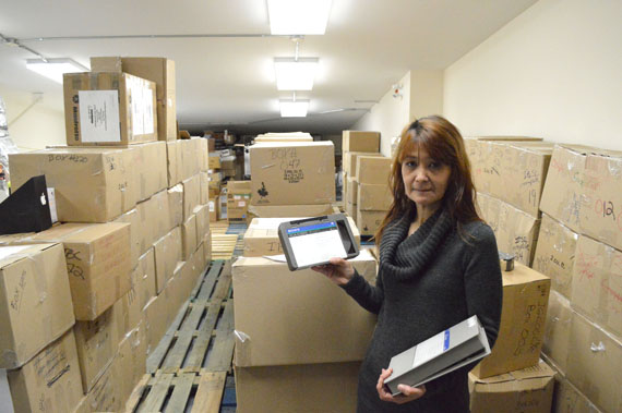 IBC archivist Loretta Kanatsiak surrounded by boxes full of old analog video recordings that she will digitize one tape at a time. (PHOTO BY STEVE DUCHARME)