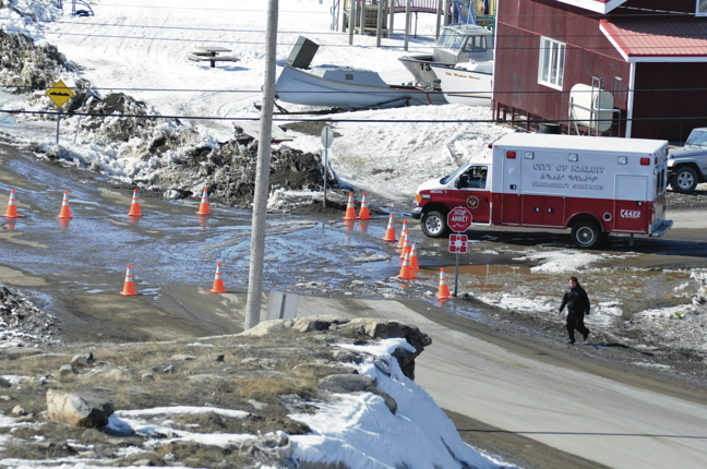 A youth walks past some barricades in Iqaluit’s Happy Valley neighbourhood, set up by RCMP so officers could deal safely with a 42-hour armed standoff in April. (PHOTO BY THOMAS ROHNER)