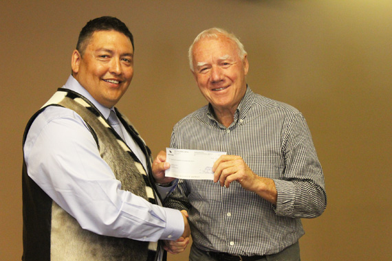 KIA president David Ningeongan, left, receives a $1.5 million cheque from Agnico Eagle Mines Ltd. chair Jim Nasso this past July 13. That payment is the first under the Inuit org's IIBA for the Meliadine gold project, which provides them with improved contracting and financial compensation measures. (PHOTO COURTESY OF AEM) 