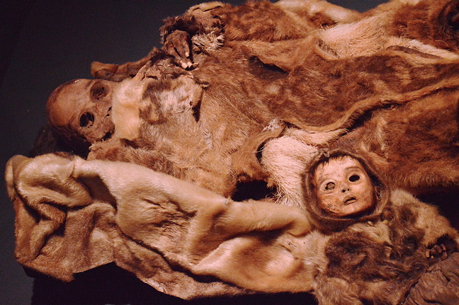 A mummified infant and mother discovered with six other individuals in a cave in 1972 near Disko Bay, on the west coast of Greenland. Experts believe the bodies were placed in their tomb around 1475 CE. 