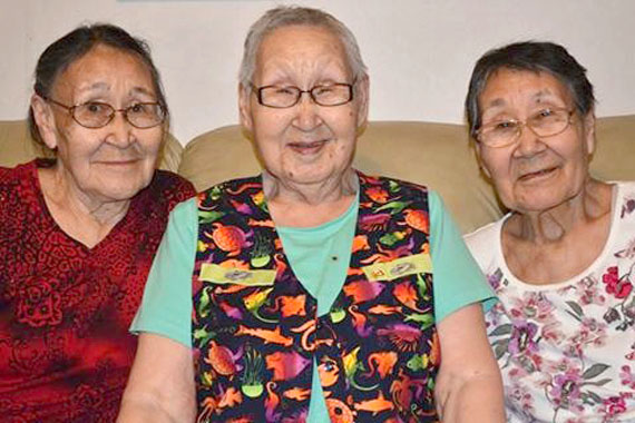 Rankin Inlet sisters Maryanne Inuaraq Tattuinee, Rhoda Karetak and Annie Napayok smile for the camera. The photo, taken by Veronica Connelly and titled Three Wise Women, won third place in the Qulliit Nunavut Status of Women's International Women's Day photo competition. An exhibition of the contest's submissions is on at the Nunatta Sunakkutaangit museum in Iqaluit until March 27. (PHOTO COURTESY OF V. CONNELLY/QULLIIT)

