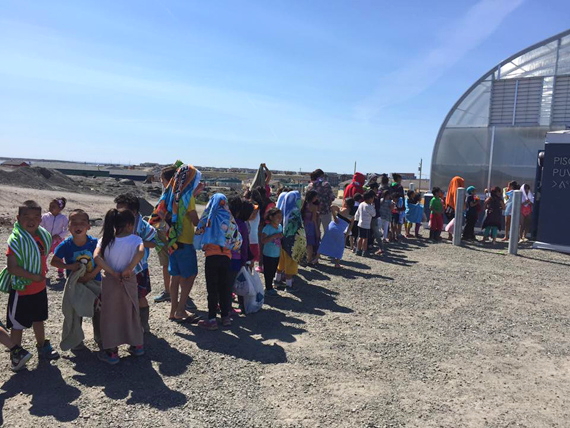 Youth in Puvirnituq wait in line in 20C temperatures July 7 for a chance to jump into the Nunavik community's brand new indoor pool, which opened this week. The new infrastructure, funded by both the municipal and regional governments, is designed like the region's other pools, housed under a greenhouse-like dome, with a maximum capacity of 43 swimmers at a time. (PHOTO BY MUNCY NOVALINGA)