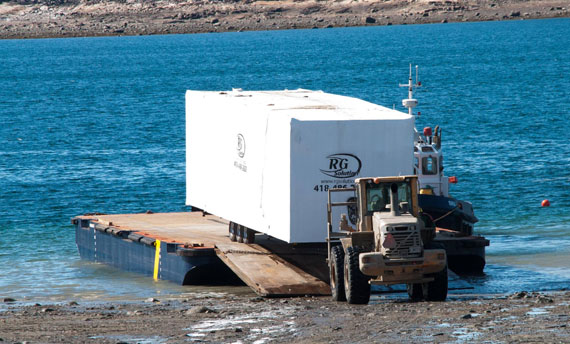 Sealift crews offload a seacan containing modular classroom parts in Cape Dorset this week. The new temporary classrooms will house high school students until a new school is built and ready to move into, likely by September 2019. (PHOTO BY CLAUDE CONSTANTINEAU)