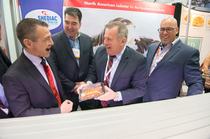 Nunavut MP Hunter Tootoo (right) in happier times, yucking it up with a group of fishing industry executives at a trade show he attended when he still served as minister of Fisheries and Oceans. After admitting to an 
