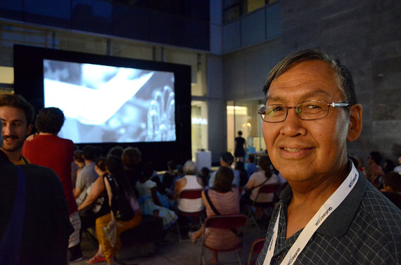 Filmmaker Jobie Weetaluktuk watches his own film, Inukshop, screened at the FOFA Gallery Courtyard Aug. 4 in Montreal as part of the Tillutarniit summer screening series. (PHOTO BY DAVID MURPHY) 