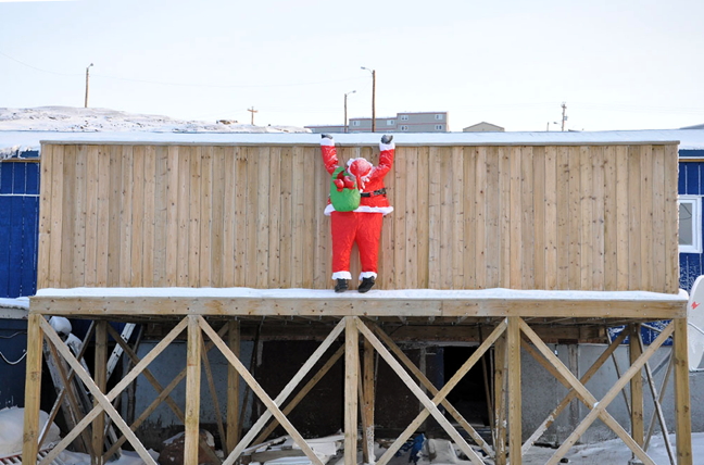 Look Ma, no carabiners! Santa Claus has been getting a little exercise in Iqaluit, and practicing his rooftop scrambling, in preparation for his round-the-world journey on Christmas Eve. Thanks to the Iqaluit homeowners here, in Happy Valley, for helping out the Jolly Old Elf. (PHOTO BY THOMAS ROHNER)