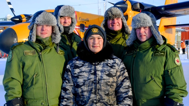 Members of 440 Transport Squadron, Maj. Anders Muckosky, Capt. Thom Doelman, Cpl. Jason MacKenzie and Capt. Dale Maedel, stand with Tyler Amarualik, one of two men they picked up Feb. 23 near Hall Beach. (PHOTO BY BELINDA GROVES/CANADIAN ARMED FORCES)