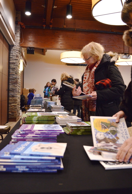 Book fans check out Inhabit Media titles at a publisher's meet-and-greet event in Iqaluit Feb. 18. The Iqaluit-based publishing house hopes to strike a balance between traditional and contemporary Nunavut stories, while avoiding being pigeonholed as an Indigenous publisher.