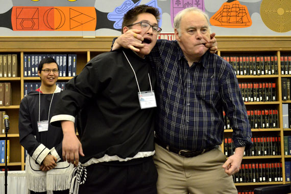 Cheeky behaviour: Gabe Klengenberg of Kugluktuk, a student at the Nunavut Sivuniksavut college program in Ottawa, and Murray Angus, a former instructor in the program, engage in a fierce face-pulling contest March 1 at Library and Archives Canada, at an event held to mark the 15th anniversary of Project Naming. Nunavut Sivuniksavut started Project Naming in 2002, when they began asking NS students to help identify Inuit represented in thousands of archival photographs held at Library and Archives Canada. Since then, more than 2,000 previously anonymous Inuit have been identified and more than 8,000 Arctic photos have been digitized. Read more later on Nunatsiaqonline.ca. (PHOTO BY JIM BELL)