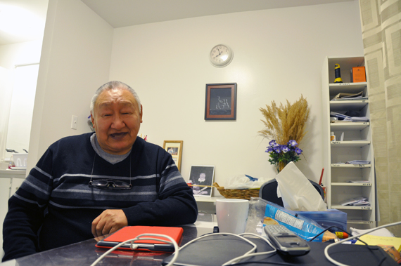 Mattiusi Iyaituk seated in his kitchen at home in Ivujivik. At 66, the sculptor still does all his carving in a small shelter behind the house. (PHOTO BY SARAH ROGERS)