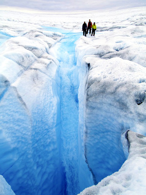 Melt water drains from a glacier in Greenland. (NATIONAL OCEANIC AND ATMOSPHERIC ADMINISTRATION PHOTO)  