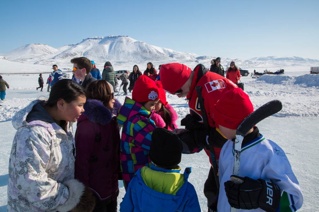 Retired NHL star Lanny McDonald signs autographs in Arctic Bay in May 2016: McDonald, and CWHL player Natalie Spooner will be touring eight Nunavut communities this year with the Stanley Cup, the Clarkson Cup and 150 bags of hockey gear to give away to local youth. (PHOTO BY CLARE KINES)