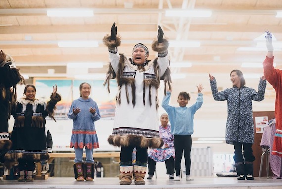 Inuinnait drummers and dancers, with Trisha Angnasiak Ogina (centre) perform Aug. 26 in Cambridge Bay as federal transport minister Marc Garneau announced new measures to protect the marine environment and coastal communities in Canada's Arctic. (PHOTO BY NATTA SUMMERKY/CANADA C3)

