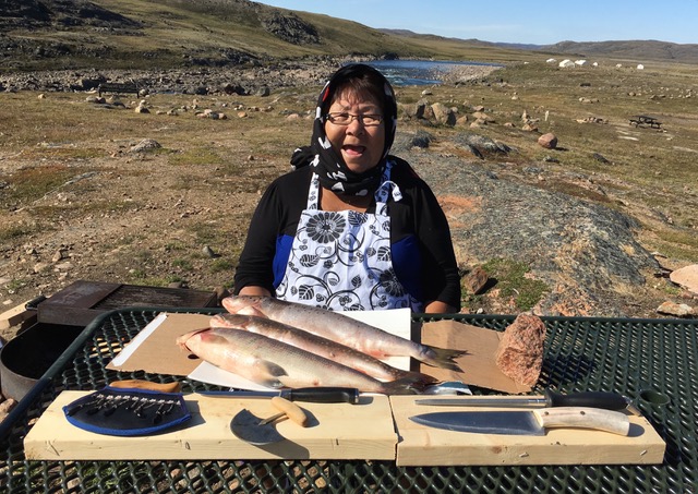 Rebecca Veevee, the host of the popular cooking show Niqitsiat, is pictured here preparing fish at Sylvia Grinnell park in Iqaluit. The Inuit Broadcasting Corp. television series is about to broadcast its final season of Niqitsiat, the first episode of which airs Monday, Jan. 8 at 10 p.m. EST on APTN. IBC is also airing the seventh and final season of its show Illinniq this year, which follows young Inuit musicians and artists across Nunavut. Illiniq airs Jan. 8 at 8:30 p.m. EST. (PHOTO COURTESY OF IBC) 
