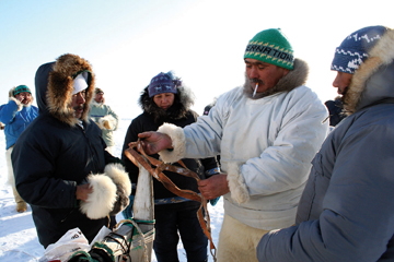Project team member Mamarut Kristiansen from Qaanaaq, Greenland, explains Qaanaaq-style dog harnesses to Clyde River team members (from left) Ilkoo Angutikjuak, Igah Sanguya and Joelie Sanguya during a trip to Qaanaaq in spring 2007. (SHARI GEARHEARD PHOTO)