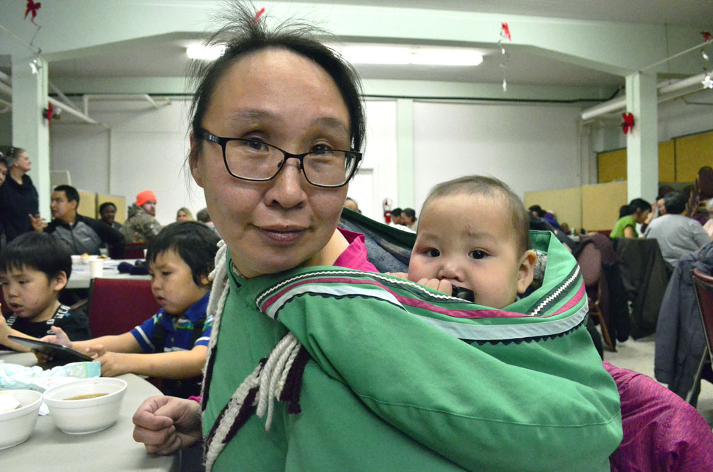 Jeannie Malliki and baby Benjamin Malliki enjoy themselves at Tungasuvvingat Inuit’s latest monthly feast, held Jan. 18 at Our Lady of Assumption Church in the Vanier neighbourhood of Ottawa. The event brought more than 200 Ottawa Inuit together to enjoy food and companionship. (PHOTO BY JIM BELL)