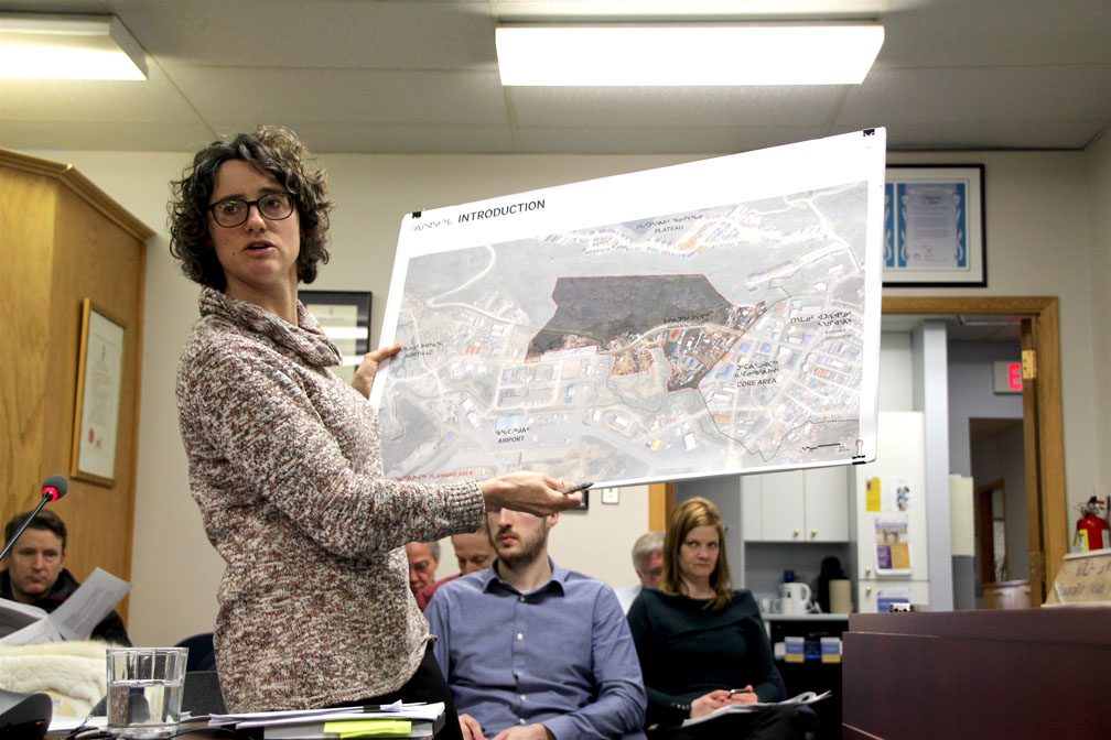 Michelle Armstrong, planning and development officer for the City of Iqaluit, displays a map showing a parcel of Inuit-owned land that the Qikiqtaaluk Corp. is seeking development permits for, during a committee meeting held earlier in April. Last week, city council approved a development permit that would let the company start building a hotel and conference centre on Federal Road in two phases. (PHOTO BY BETH BROWN)
