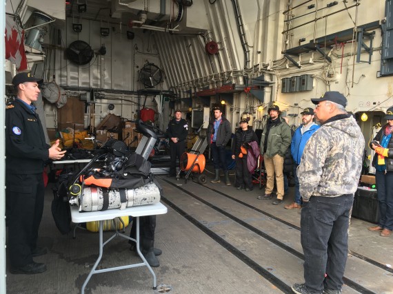 Sub-Lieutenant Jaidon Freeland tells a group of Iqaluit residents what it’s like to be a Navy diver during a tour of HMCS Charlottetown today. The vessel has just finished taking part in Operation Nanook, the Canadian military’s annual Arctic military exercise. Scenarios took place in Frobisher Bay this weekend, following a trip to Greenland. (PHOTO BY BETH BROWN)