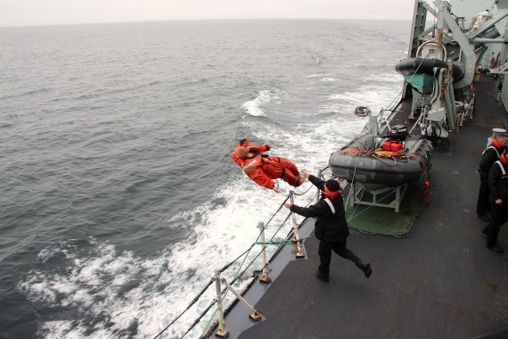 A sailor throws a practice dummy over the side of the HMCS Charlottetown on Aug. 28 during a man-overboard drill. (PHOTO BY BETH BROWN)