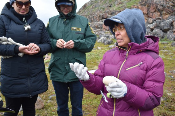 Leesee Papatsie explains the traditional Inuit uses of these white mushrooms that grow on the tundra. She says women would pop a mushroom to use as a moisturizer when they knew their husband was returning from a long hunting trip, to make their skin silky smooth. (PHOTO BY COURTNEY EDGAR)