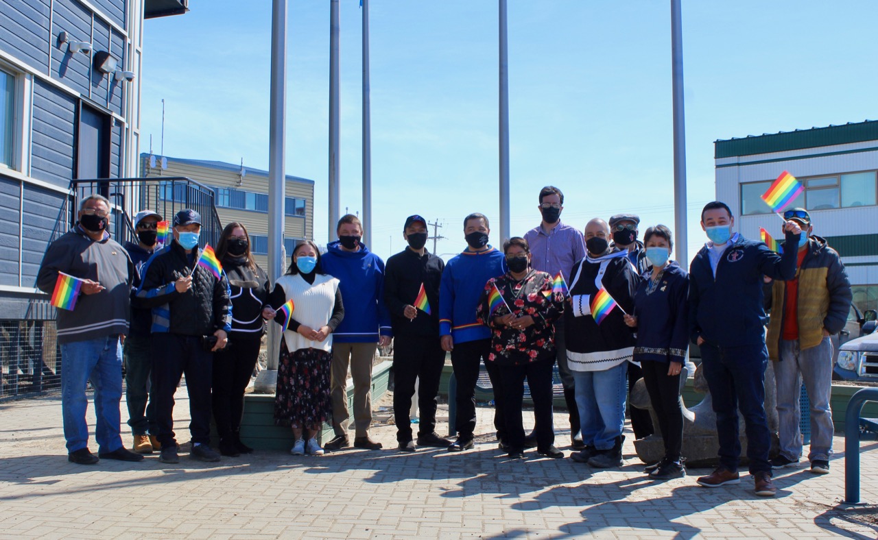 Nunavut MLAs pose for a photo after raising the Pride flag outside Nunavut’s legislative assembly on June 1 to mark the first day of Pride Month, which celebrates the LGBTQ community. It’s the first time the territory’s legislative assembly has raised the Pride flag. (Photo by Emma Tranter)